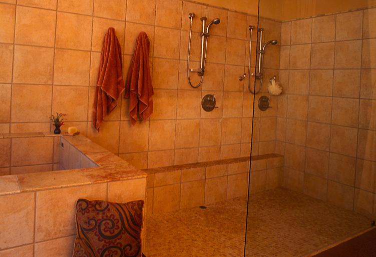 In the master bath, designer Deborah Coburn used a moderately priced field tile to line the shower and soaking tub. Tumbled marble adds a lavish accent.